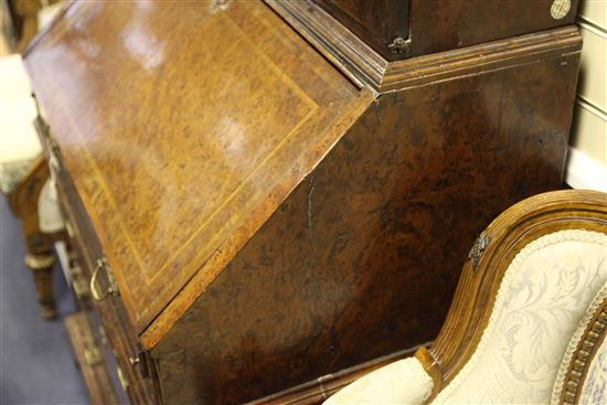 A Queen Anne walnut and featherbanded bureau cabinet, W.3ft 5in.